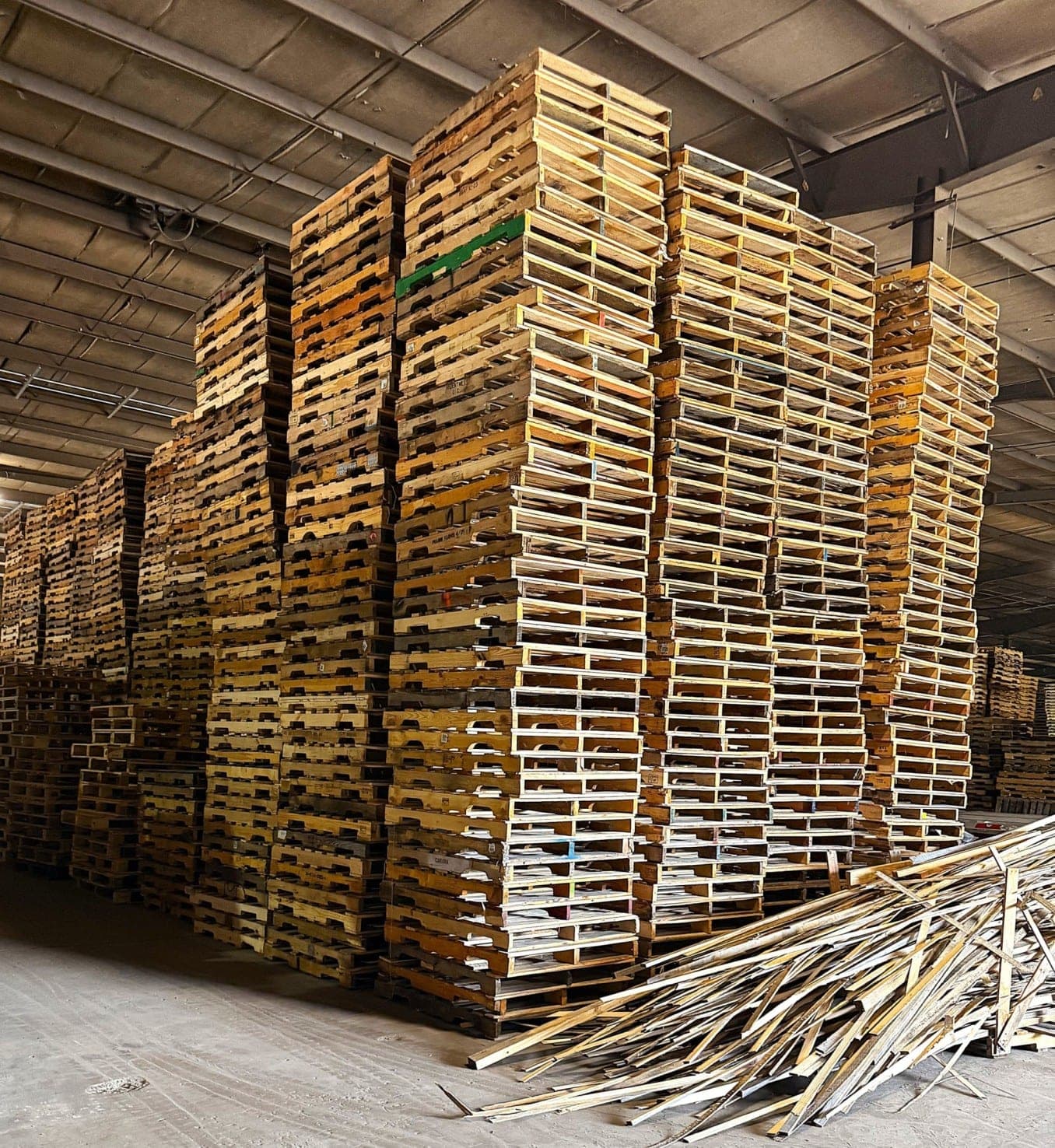 Stacks of used wood pallets ready for Southern Pallet pickup and recycling
